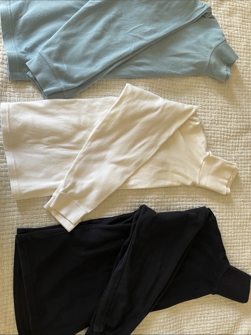 Three Ribbed Turtleneck Tops in Blue, Cream, and Black